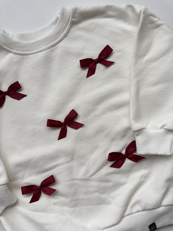 Bluza ecru z kokardkami 92