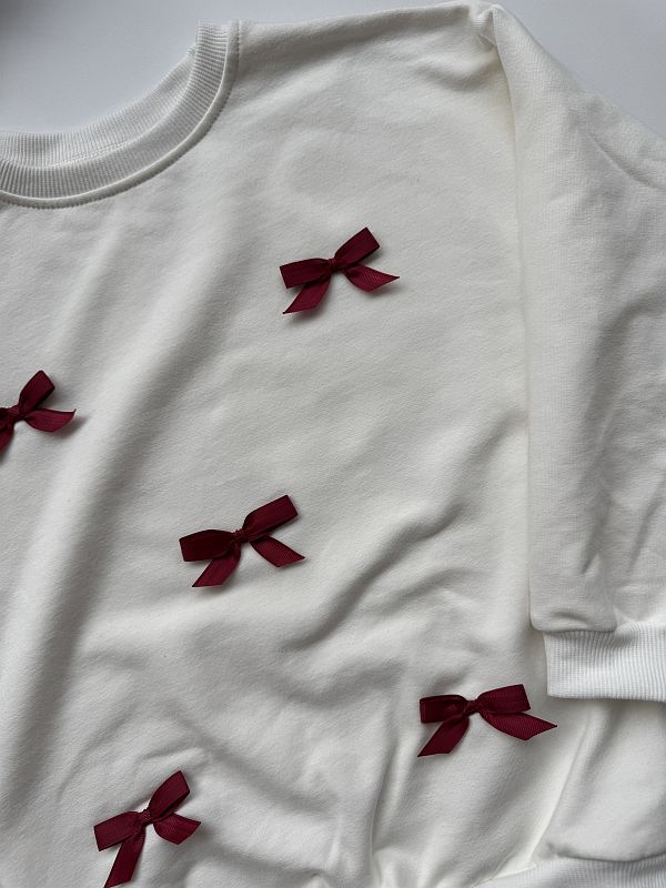 Bluza ecru z kokardkami 128