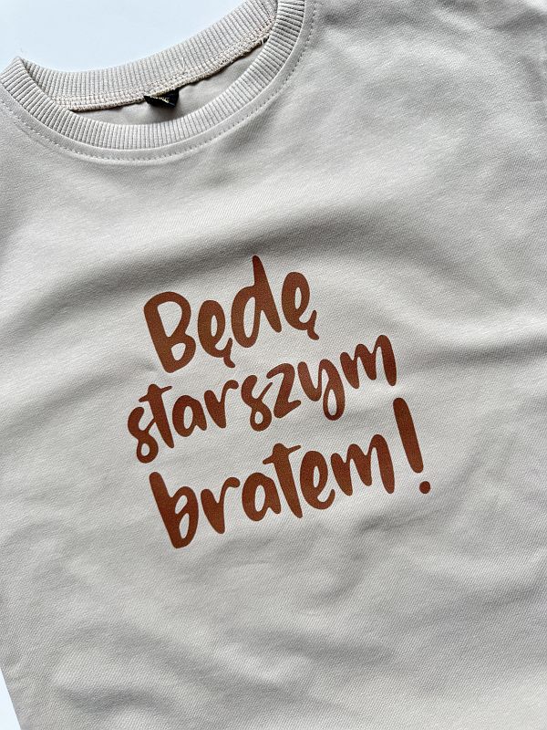 Koszulka beżowa z krótkim rękawem będę starszym bratem rozmiar 98