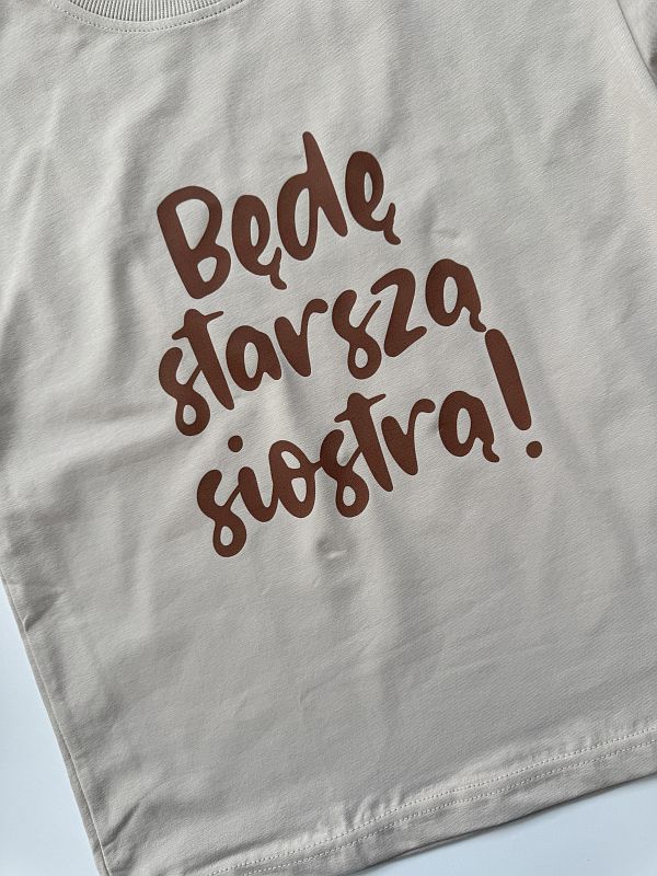 Koszulka beżowa z krótkim rękawem będę starszą siostrą rozmiar 128